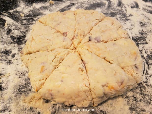 Scone dough is shaped into a 9" circle, and cut into eight wedges.