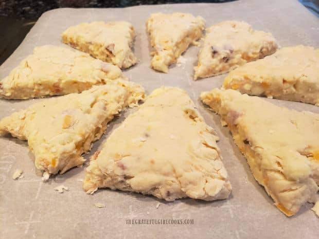Scone dough, sliced in 8 wedges and placed on parchment paper-lined pan for baking.