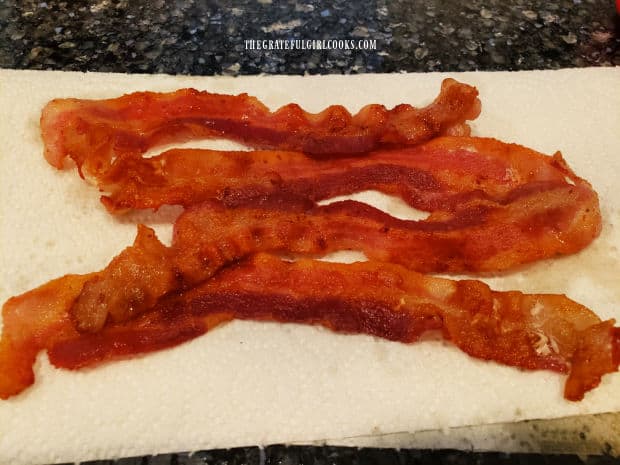 Cooked bacon slices, draining on paper towels to absorb grease.