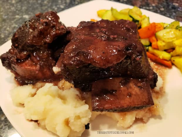 Beef short ribs for two, served on top of mashed potatoes and drizzled with sauce.