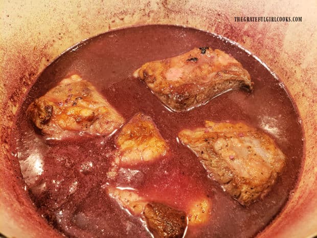 Beef broth is added to red wine sauce to almost cover the short ribs, then baked.