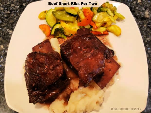 Beef Short Ribs For Two is a decadent dish! Short ribs are baked in butter, garlic, & red wine sauce until they're "fall off the bone" tender!