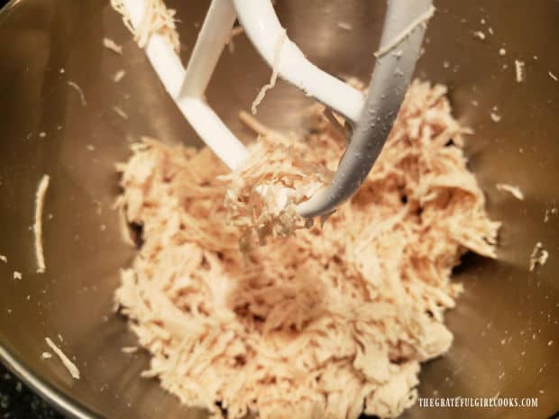 The stand mixer completely shreds the cooked chicken breast quickly.