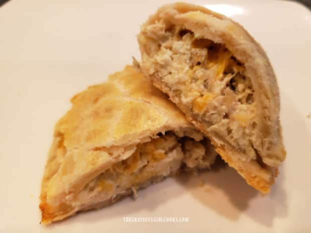 One of the hand pies cut open, revealing the chicken filling inside.