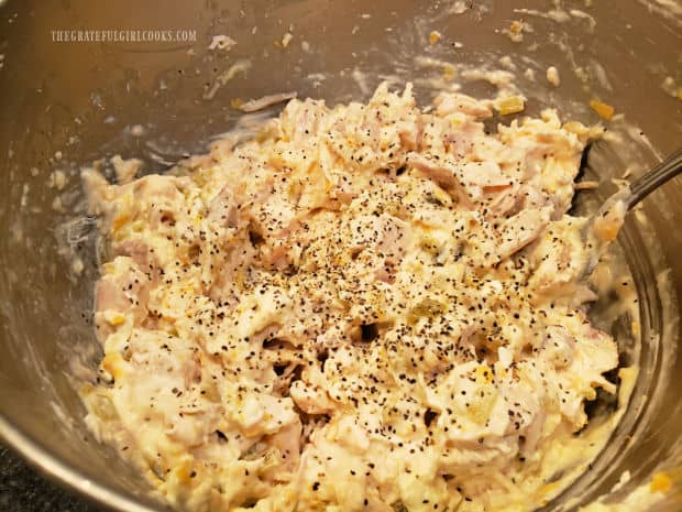 Spices are added to the chicken cream cheese mixture in bowl.