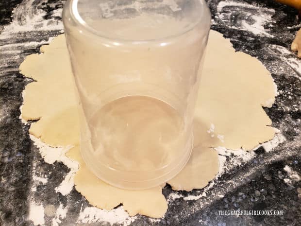 Circles are cut out of pie dough using overturned jar.
