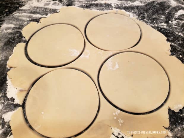 Five inch circles are cut out of the pie dough.