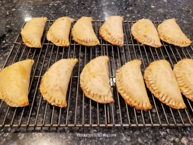 Chicken Suizas Hand Pies rest on wire rack after baking.