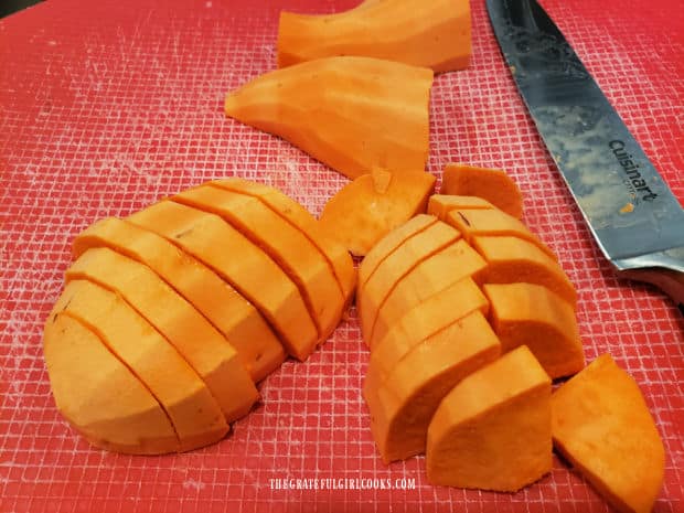 Two peeled sweet potatoes are cut in half, then sliced into pieces.