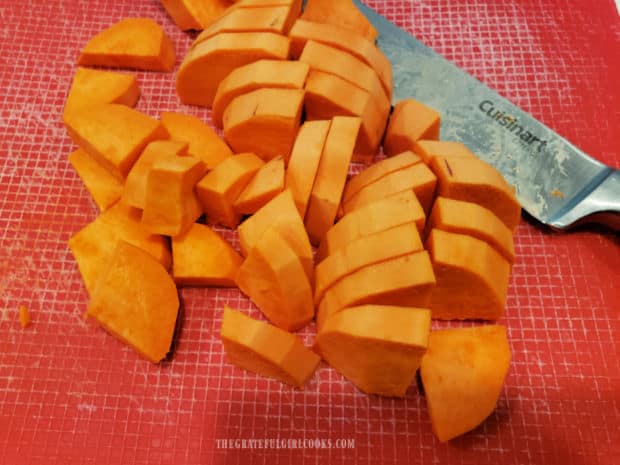 Sweet potatoes are sliced into quarter-sized wedges before baking.