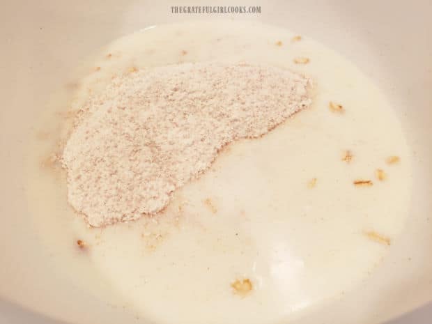Dry ingredients for pancakes are added to the soaked oats in milk.