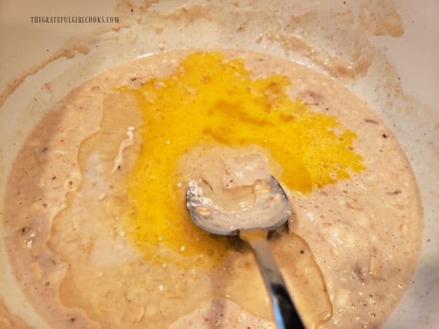 An egg and oil are added to the pancake batter, and stirred to combine.