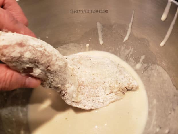 A flour-coated rockfish fillet is covered with a wet beer batter on all sides.