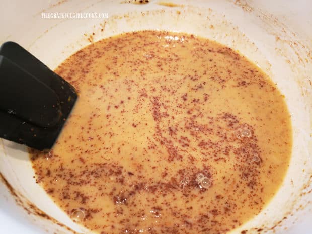 A large white bowl of egg/cinnamon mixture, ready for the French toast.