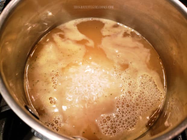 Rice is added to the butter and broth mixture and cooked for 20 minutes.