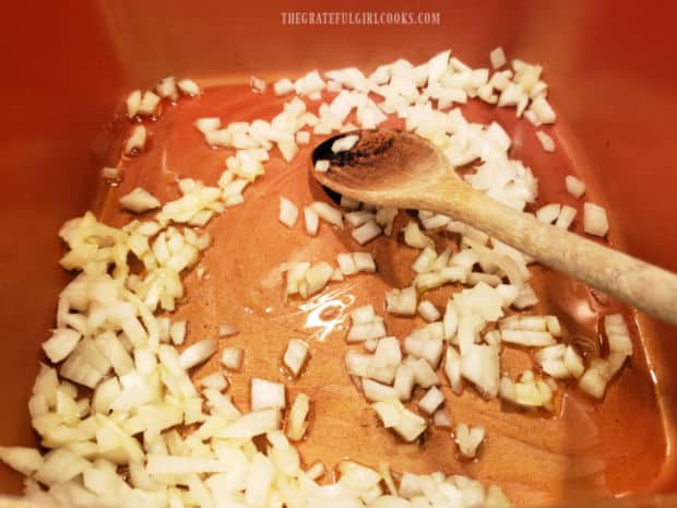 Chopped onion is cooked in hot oil in a large saucepan for about 5 minutes.