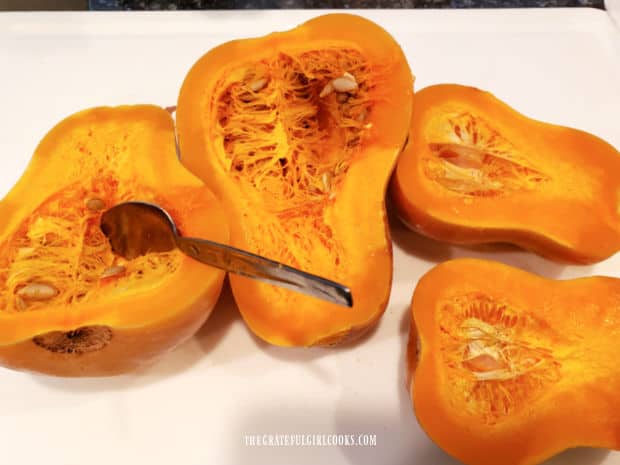 After microwaving, the seeds and pulp are removed from the squash.