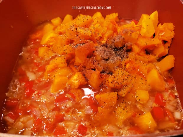 Butternut squash, chicken broth and spices are added to the soup pan.