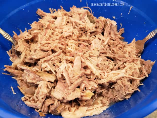 Large blue bowl, full of the easy slow cooker pulled pork, ready to be used.