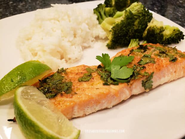 Garlic lime baked salmon served with lime wedges, rice and broccoli on the side.