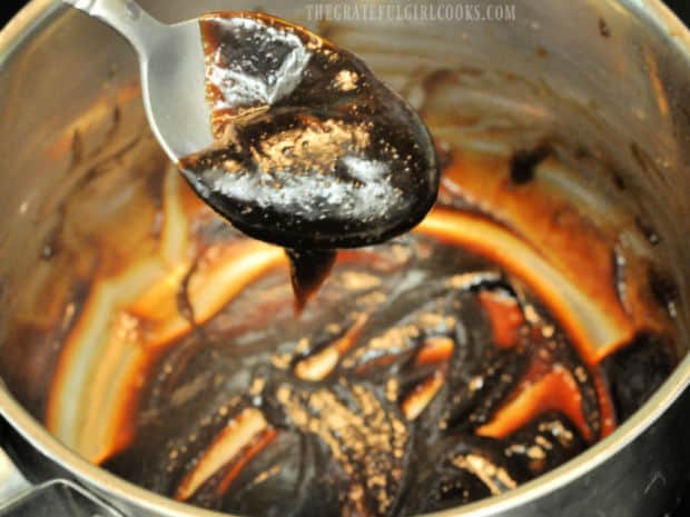 Close up photo of homemade version of hoisin sauce on a spoon.