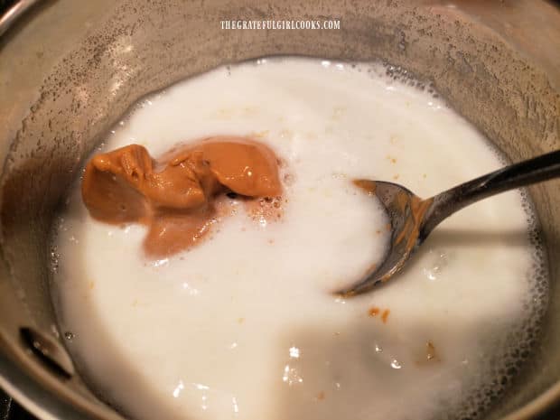 Peanut butter is adding to the hot ice cream sauce, and stirred while it melts.