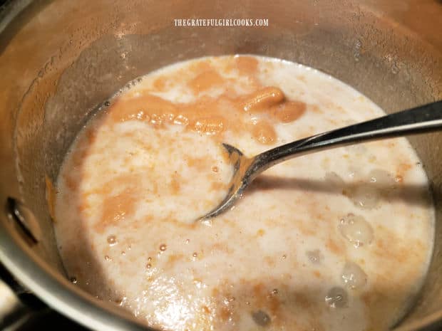 Peanut butter, slowly melting into the sauce in pan, while being stirred.