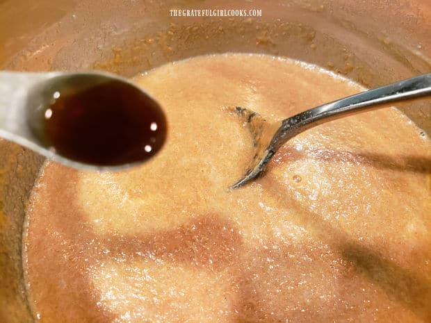 Vanilla extract is added to cooled peanut butter sauce (off of the heat).