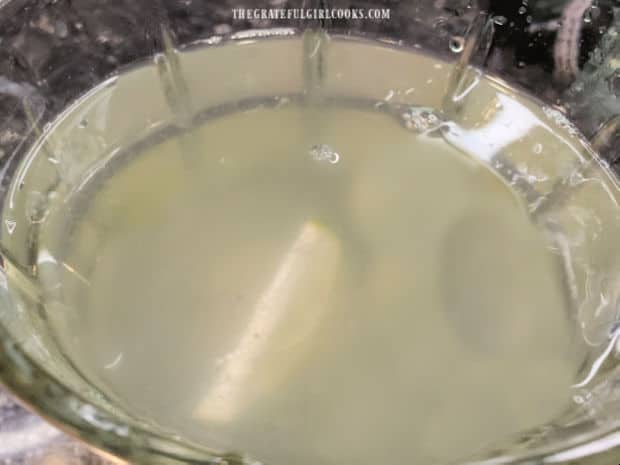A second lime is cut into wedges and added to the water in the pitcher.