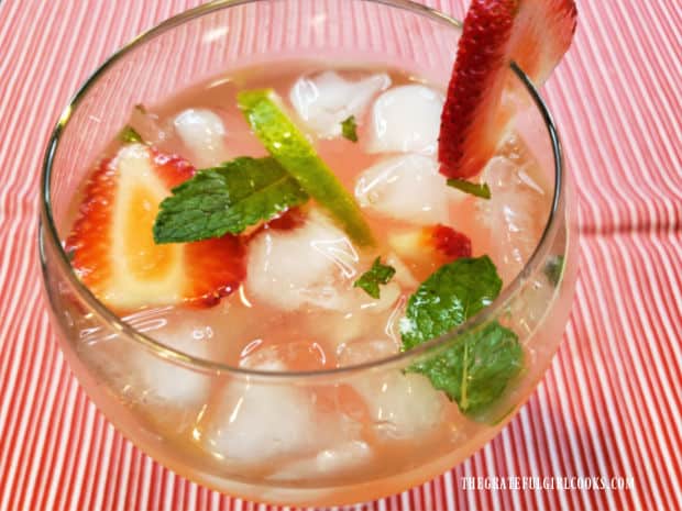Strawberry mint lime agua fresca is served cold, over ice cubes in a glass