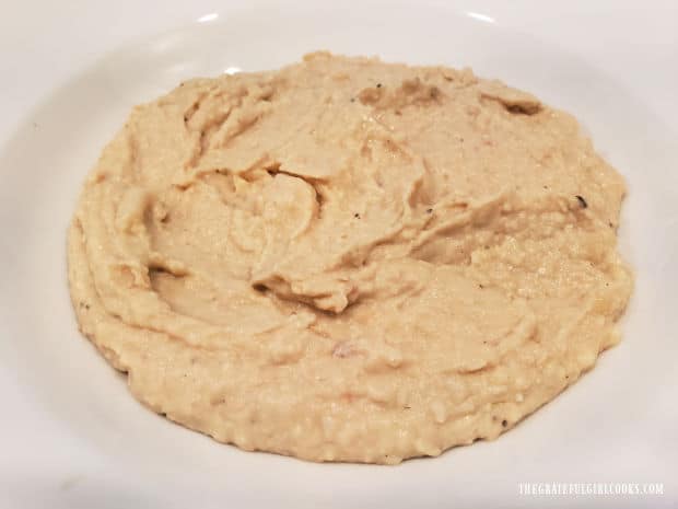 After processing until smooth, cannellini bean dip is placed in serving bowl.