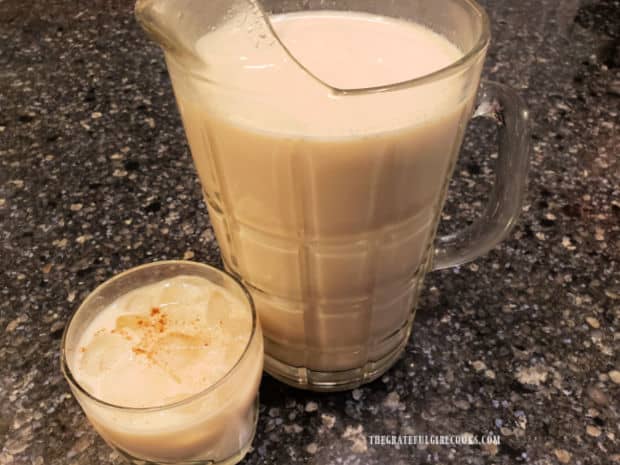 A pitcher and a glass, filled with Classic Mexican Horchata, ready to enjoy.