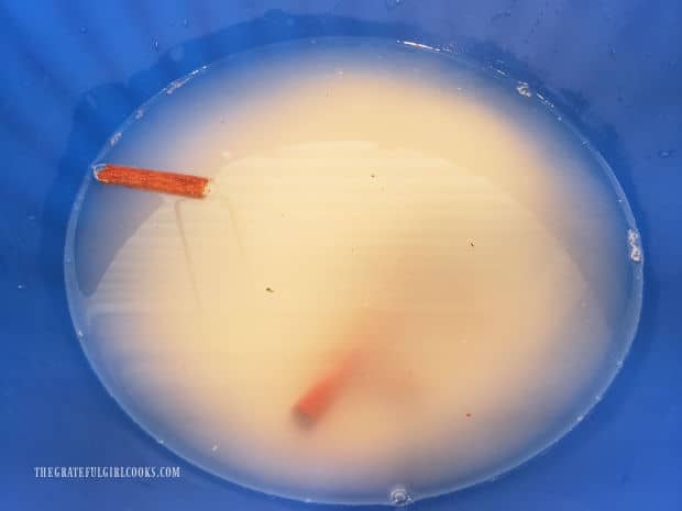 Water is added to the bowl, to soak cinnamon sticks and rice.