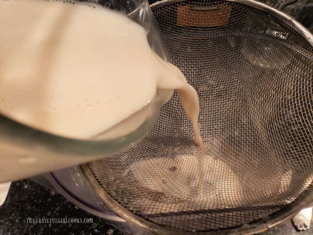 Blended rice, cinnamon sticks and water are strained into a large pitcher.