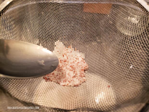 Some of the cinnamon pulp is left in strainer and is discarded.