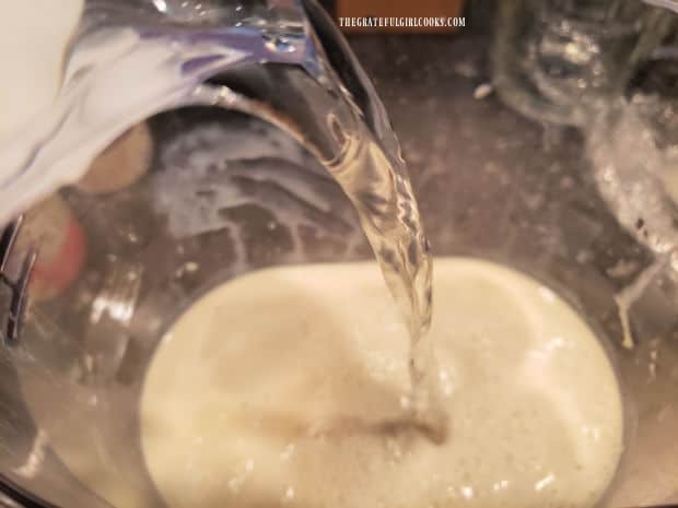 Additional water and vanilla extract are added to the pitcher of horchata.