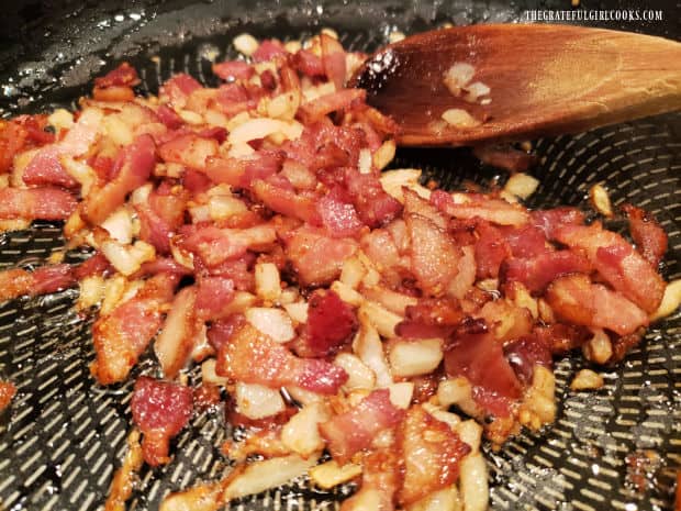 Bacon, onions and garlic, fully cooked, are transferred out of the skillet.