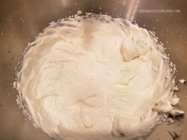 Whipping cream ingredients are mixed with electric beater until stiff peaks form.