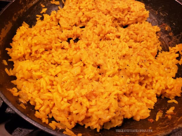 Spiced yellow rice is done cooking, and liquid is absorbed.