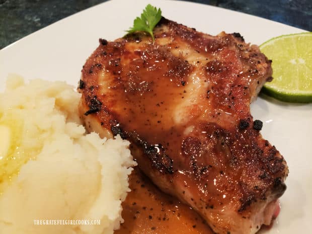 Vietnamese Skillet Pork Chops with sauce, mashed potatoes and lime wedge.