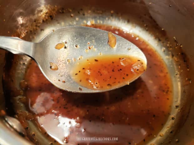 Pan sauce is reduced in quantity by boiling, leaving small amount in pan.