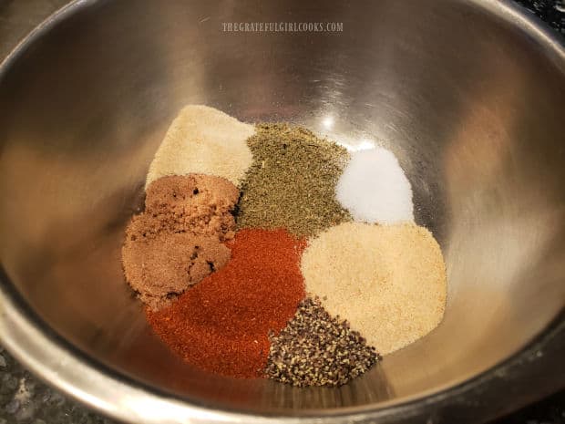 Spices are placed in a bowl and they'll be used to season the chicken.