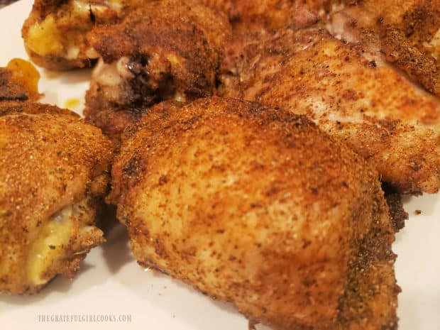 A close up of the baked chicken on a white plate, ready for serving.