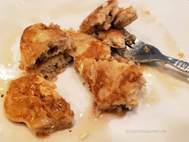 Some small bites of the banana oat pancakes on plate, with syrup.