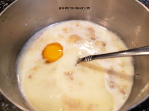 An egg, milk, mashed banana and oil are placed in mixing bowl.