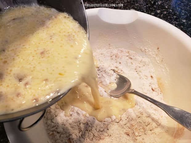 Wet ingredients are poured into the dry ingredients for the pancake batter.