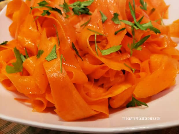 Chopped fresh parsley leaves garnish the carrot ribbon salad.