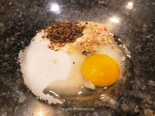 Egg, sugar, salt, dill seed, dried onions and baking soda in a large, clear bowl.