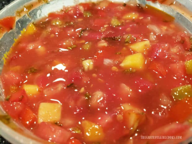 Mango peach salsa is used to garnish cooked halibut for serving.