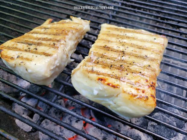 The halibut fillets are flipped halfway through cooking, and brushed with sauce.